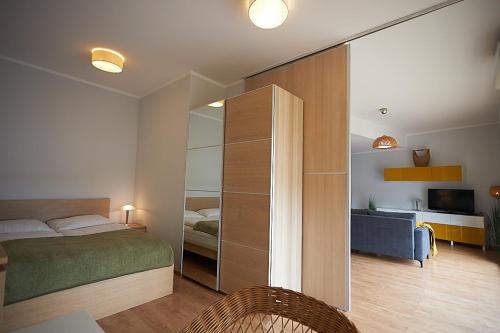- une chambre avec un lit, un bureau et une télévision dans l'établissement Apartamenty Świnoujście Villa Concha, à Świnoujście