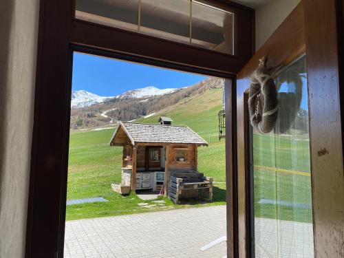 a view of a cabin through a window at Mountain Chalet Milly in Livigno