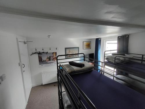 a room with two bunk beds and a window at Plymouth Backpackers in Plymouth