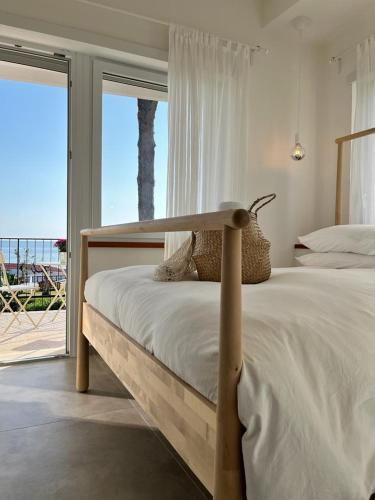 a bedroom with a bed with a view of the ocean at Villa Maria Luxury Suites in Sperlonga