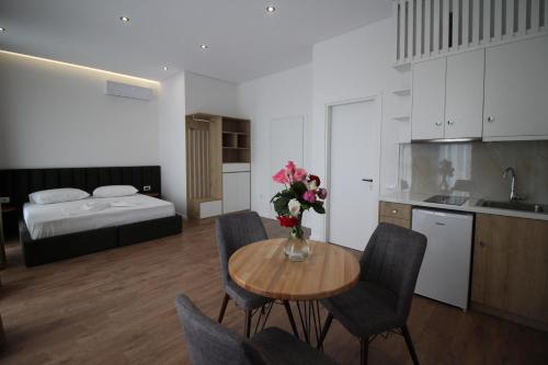 a kitchen and dining room with a table with flowers on it at JUER Hotel in Bajkaj