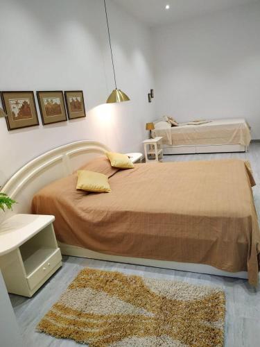 a bedroom with a large bed and a rug at Jasmin at Bayview in Pembroke