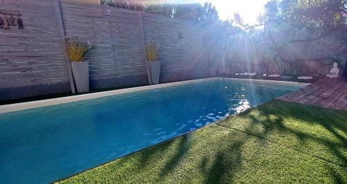 a swimming pool in a yard next to a wall at Villa Clea in Saint-Paul-lez-Durance