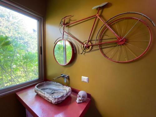 a bathroom with a bike hanging on the wall at Casarte Boutique Hotel in Playa del Carmen