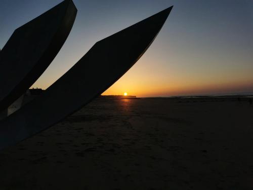 a view of the sunset through the wing of an airplane at Gites les Pourquoi Pas - Résidence de Tourisme DSV Bayeux in Bayeux