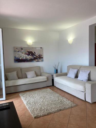 a living room with two couches and a rug at Casa di Giorgio in Jelsa