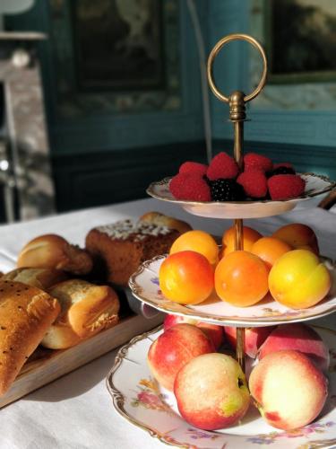 a table with three tiered plates of bread and fruit at B&B Huis der Boede in Koudekerke