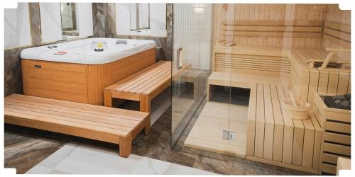 a bathroom with a tub and a sink and a toilet at Arkadia in Radziejów