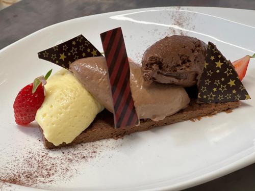a white plate with different types of desserts on it at Au Père Tranquille in Tinchebray