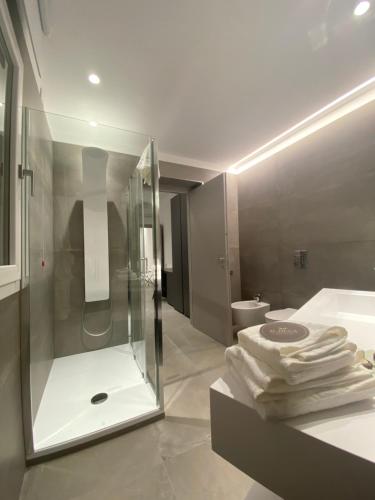 a bathroom with a shower and a sink with towels at IL DUCA HOUSE e HOLIDAY PRESTIGE in Caccamo