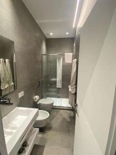 a bathroom with a toilet and a sink and a shower at IL DUCA HOUSE e HOLIDAY PRESTIGE in Caccamo