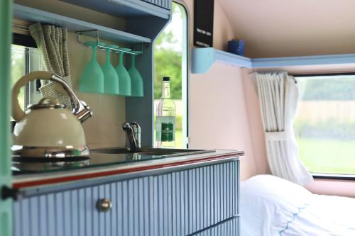 a kitchen with a sink in a caravan at Beverley Thrills Caraglamping in Stratford-upon-Avon