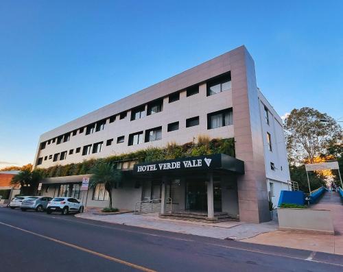 a large white building on the side of a street at Verde Vale Hotel in Videira