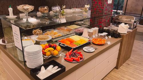 a buffet with many different types of food on display at Verde Vale Hotel in Videira