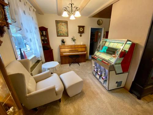 una sala de estar con una consola de videojuegos y una habitación con un snidden en Ferienwohnung zur Bierliebe - Mit toller Aussicht im Herzen des Schwarzwaldes, en Hornberg