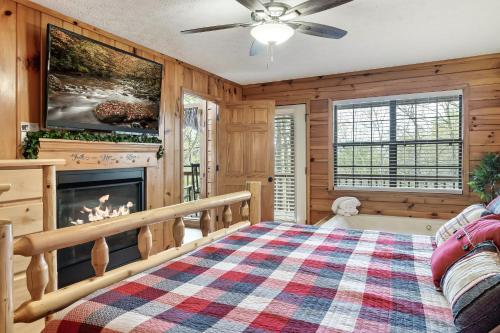 a bedroom with a fireplace and a bed at Lazy Bear Den in Sevierville