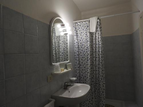 a bathroom with a sink and a shower curtain at Appartamenti Lungomare Circeo in San Felice Circeo