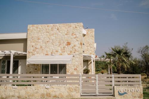 a house with a white fence in front of it at casale in Nikiti