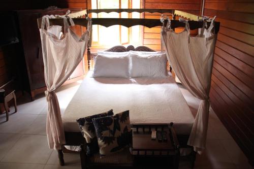 a bed in a room with mosquito nets at Hotel Fazenda Lago São Francisco in São João