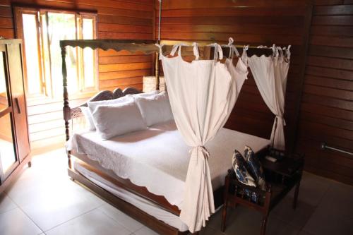 a bedroom with a bed with a canopy at Hotel Fazenda Lago São Francisco in São João