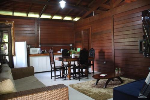 a living room with a table and a kitchen at Hotel Fazenda Lago São Francisco in São João