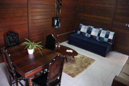 a living room with a table and a couch at Hotel Fazenda Lago São Francisco in São João