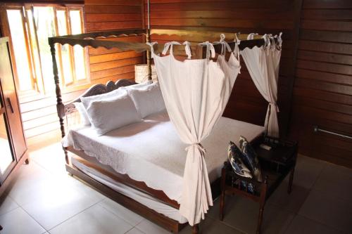 a bedroom with a bed with a canopy at Hotel Fazenda Lago São Francisco in São João