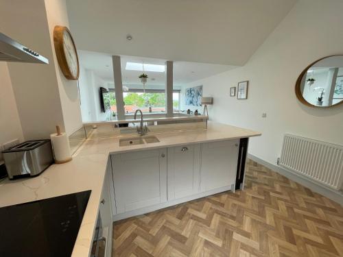 a kitchen with a sink and a counter top at Lees Lookout Holt ,2 bedroom luxury apartment with private parking in Holt