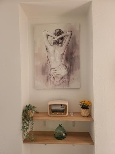 a drawing of a woman sitting on a shelf with a clock at Appartement zen et calme, centre ville in Vendôme
