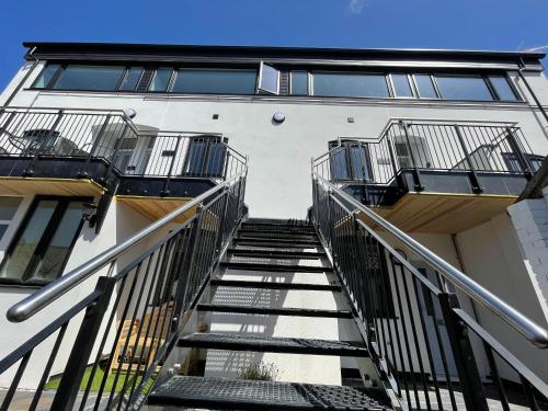 a staircase leading up to an apartment building at Lees Lookout Holt ,2 bedroom luxury apartment with private parking in Holt