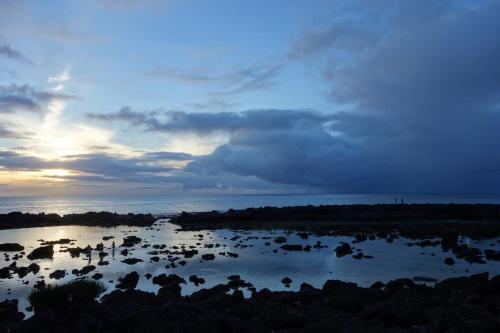 a river with a group of rocks in the water at Waimea Bay Garden Bunglaow in Haleiwa