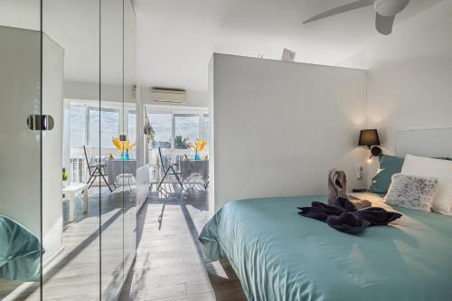 a bedroom with a bed and a glass wall at Juan el fuerte in Torremolinos