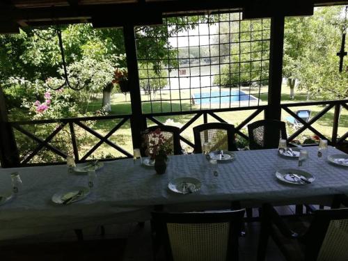 a table with a table cloth on it with a view of a pool at Vila Marina na obali Dunava in Neštin