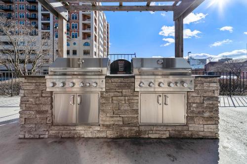 an outdoor kitchen with two burners on a patio at Kasa Downtown South Bend in South Bend