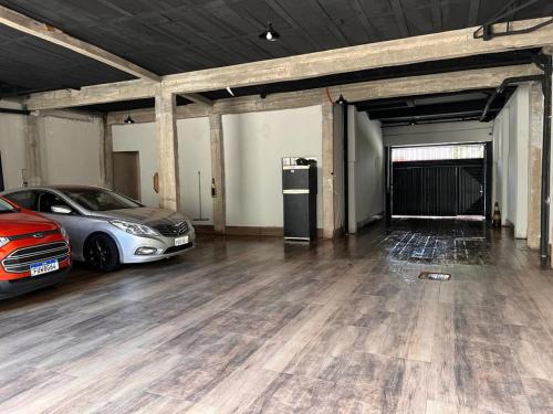two cars parked in an empty parking garage at Suites Stival Centro in Goiânia