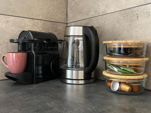 a coffee maker sitting on a counter with other items at Bed en Koffie Casa Mañana de Koog in De Koog
