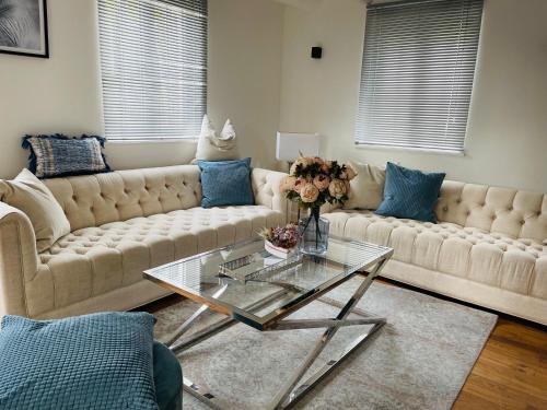 a living room with two couches and a glass table at Haus Mees Apartments in Wuppertal