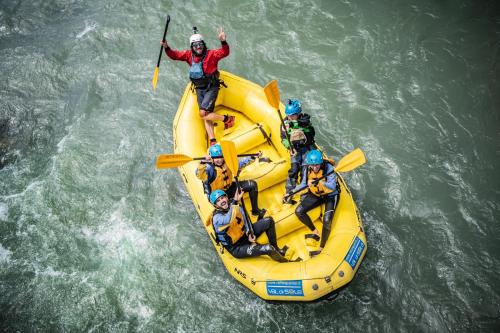 a group of people on a raft in the water at Hotel Eccher 3 stelle Superior in Mezzana