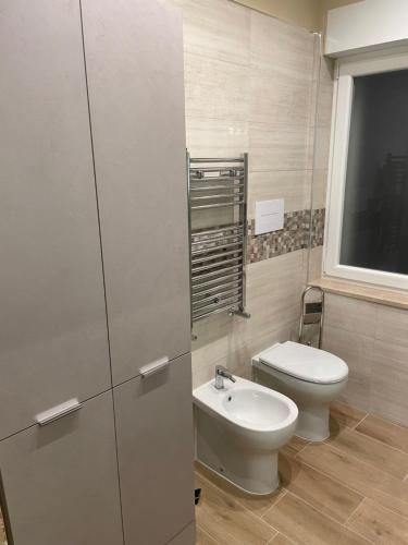 a bathroom with a toilet and a sink at Dimora Lucia in Troia