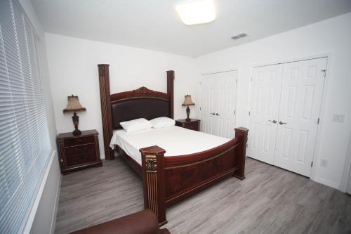 a bedroom with a large bed and two night stands at A beautiful queen bedroom in Orlando