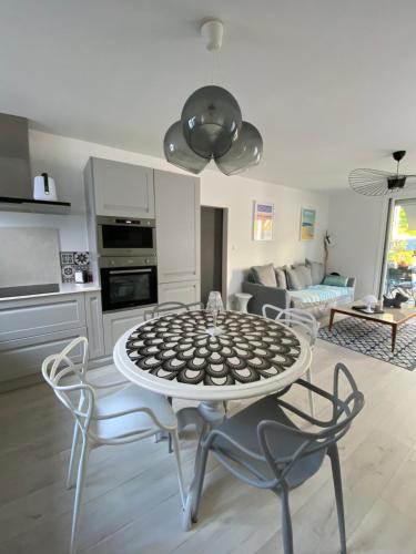 a kitchen and living room with a table and chairs at Calme et ensoleillée Maison au pied de la plage entre St Palais sur Mer et Royan in Vaux-sur-Mer