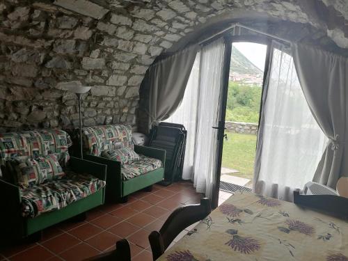 a room with two chairs and a table and a window at Casa Sasso in Tavernola Bergamasca