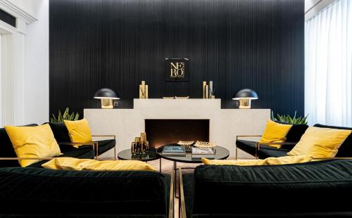a living room with two couches and a fireplace at Nero Luxury Suites in Cagliari