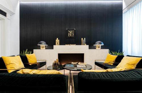 a living room with two couches and a fireplace at Nero Luxury Suites in Cagliari