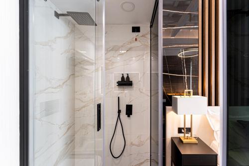 a shower with a glass door in a bathroom at Nero Luxury Suites in Cagliari
