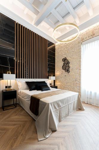 a bedroom with a large bed and a large window at Nero Luxury Suites in Cagliari