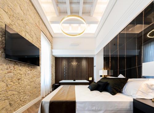 a bedroom with a large bed and a large window at Nero Luxury Suites in Cagliari