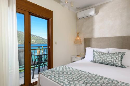 a bedroom with a bed and a view of the ocean at Faros View in Kinira
