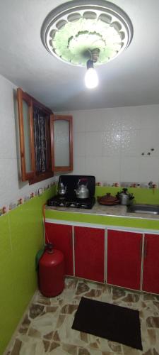 a kitchen with a stove and a green counter top at Casa Lotfi 1 in Chefchaouene
