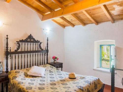 a bedroom with a bed with a hat on it at House is located on a corner in Montemor-o-Novo
